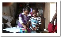 Haile's daughter and a random friend using the ink stamps we gave them